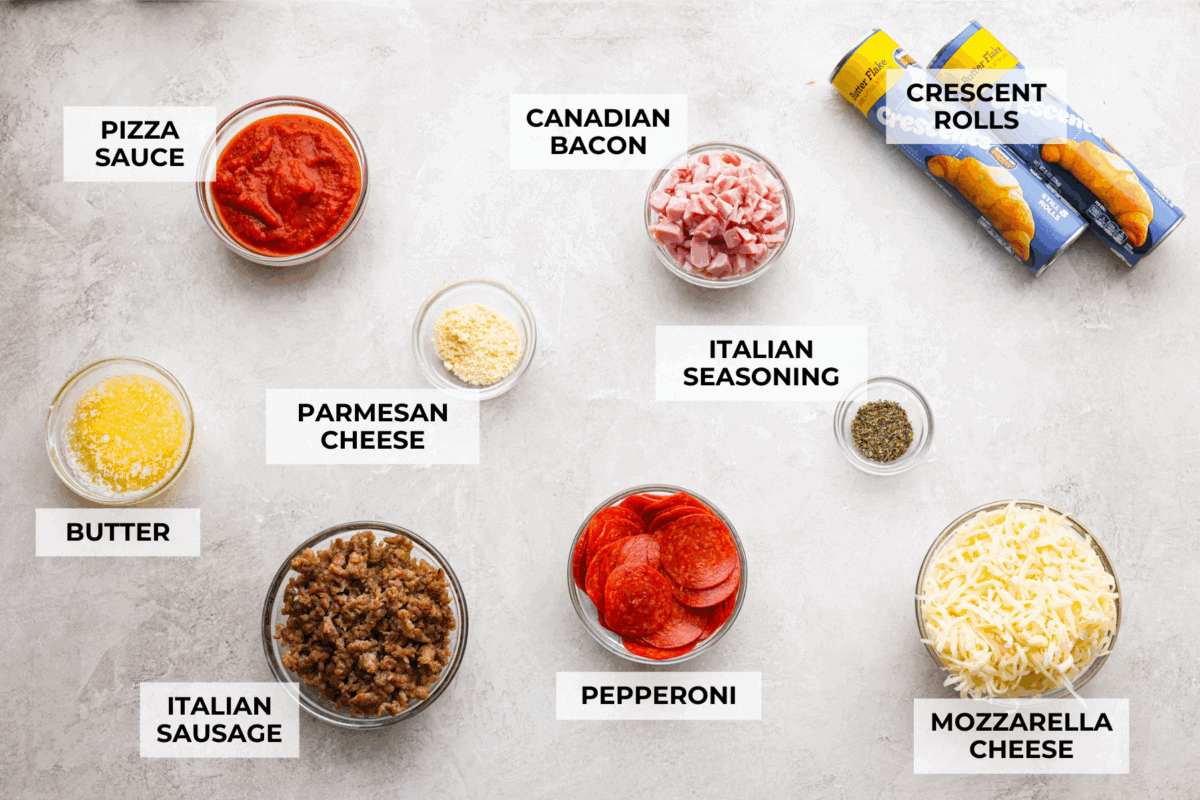 Pizza night just got a glow-up!ย This fun pull-apart pizza ring is perfect for family dinner, game day, or a party snack. Easy to make, endlessly customizable, and totally kid-approved, youโll be reaching for slice after slice! Overhead shot of labeled pizza ring inrgredients.
