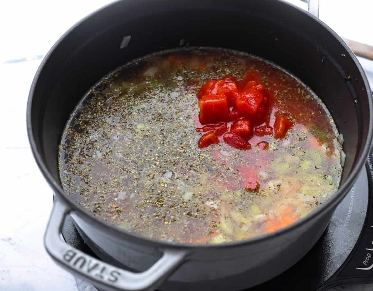 My love of cozy soups kicks in the second summer fades. This creamy tortellini soup gives me all the fall vibes. Fresh veggies, cheesy pasta, and a creamy broth, it's comfort in a bowl. Youโve got to try it today! Vegetable broth, tomatoes, and seasonings added to the pot.