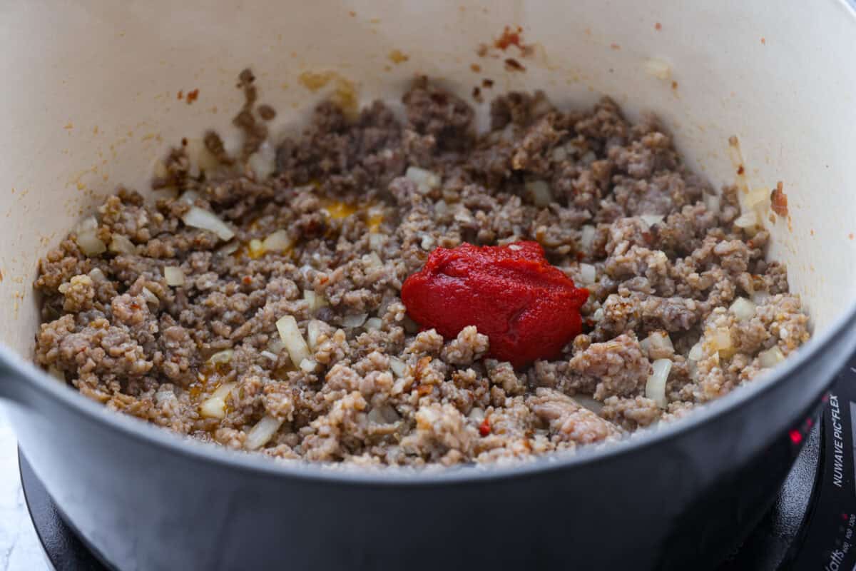 Million Dollar Soup is creamy, comforting, and worth every indulgent bite! The rich tomato soup base is loaded with sausage, cheesy ravioli, and heavy cream. The dollop of ricotta cheese on top is a MUST! Tomato paste added to the meat mixture.