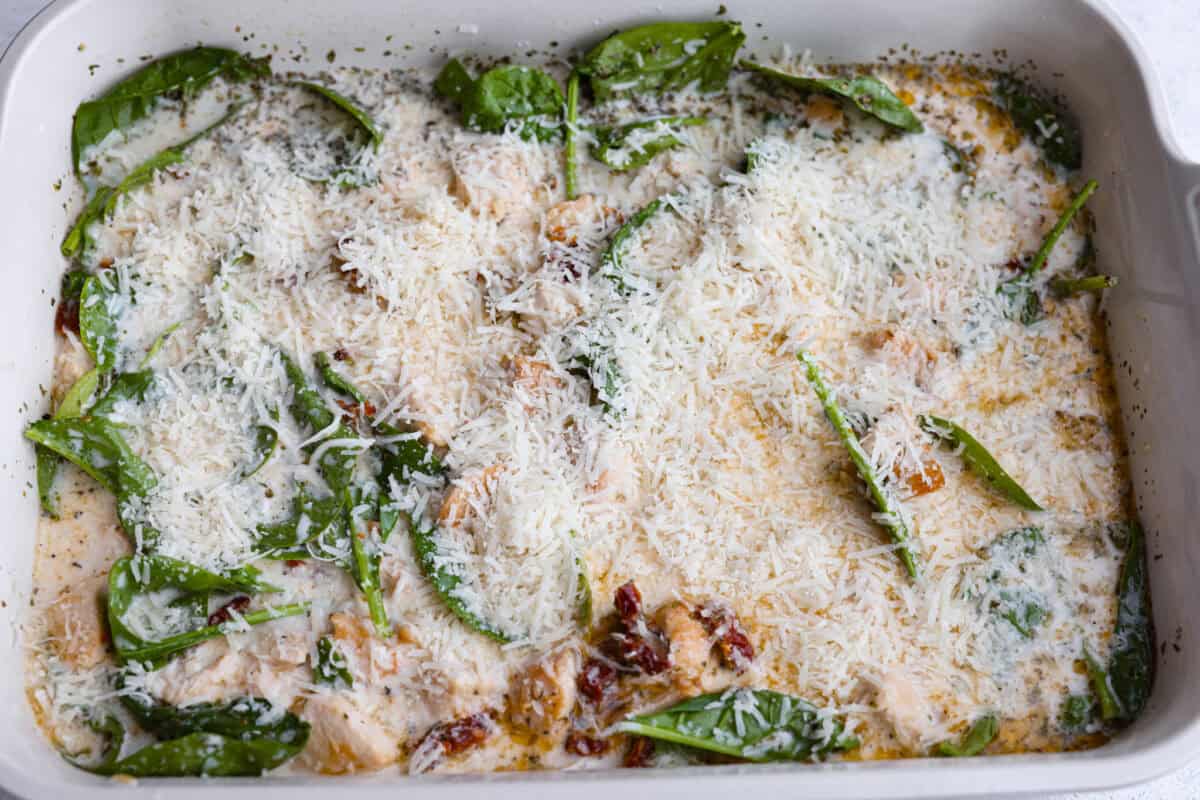 This creamy Tuscan chicken orzo bake is the kind of dinner youโll want on repeat! Tender chicken, orzo, and sun-dried tomatoes bake together in one pan for an easy, comforting weeknight meal. All of the ingredients stirred together and covered with parmesan cheese.