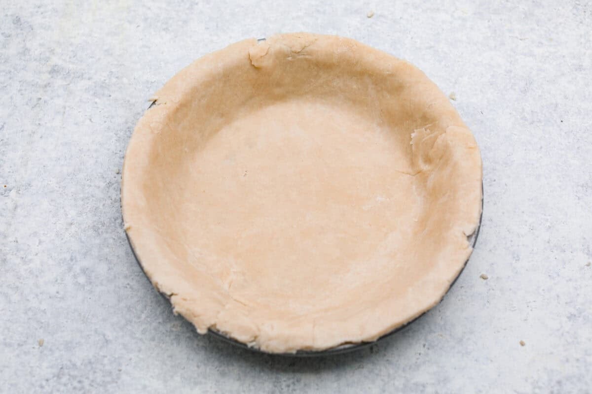 This brown bag apple pie is simple, foolproof, and downright delicious! The secret? It bakes right inside a paper bag, keeping the crust golden, the filling perfectly tender, and your oven mess-free. Rolled out dough placed into a pie tin.