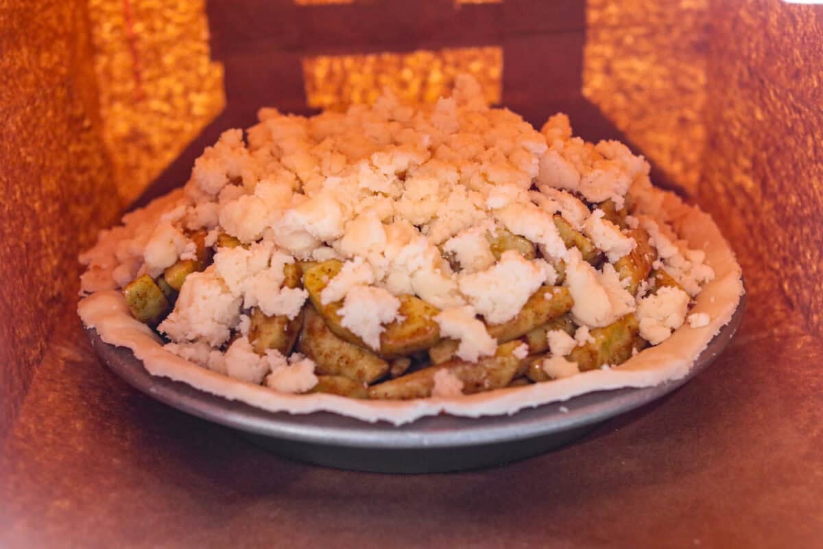 This brown bag apple pie is simple, foolproof, and downright delicious! The secret? It bakes right inside a paper bag, keeping the crust golden, the filling perfectly tender, and your oven mess-free. Topping added on top of the brown bag apple pie filling and the whole pie placed inside a paper bag.