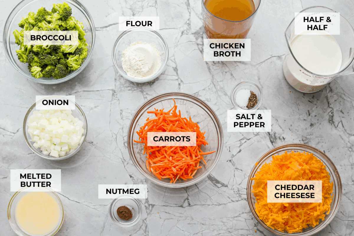 I promise that with just one bite of this copycatย Panera Breadย Broccoli Cheddar Soup, you'll be hooked! It's ultra creamy with broccoli, shredded carrots, and a hint of nutmeg, all cooked together with melted cheese. This soup is delicious and easy to make! Overhead shot of labeled ingredients.