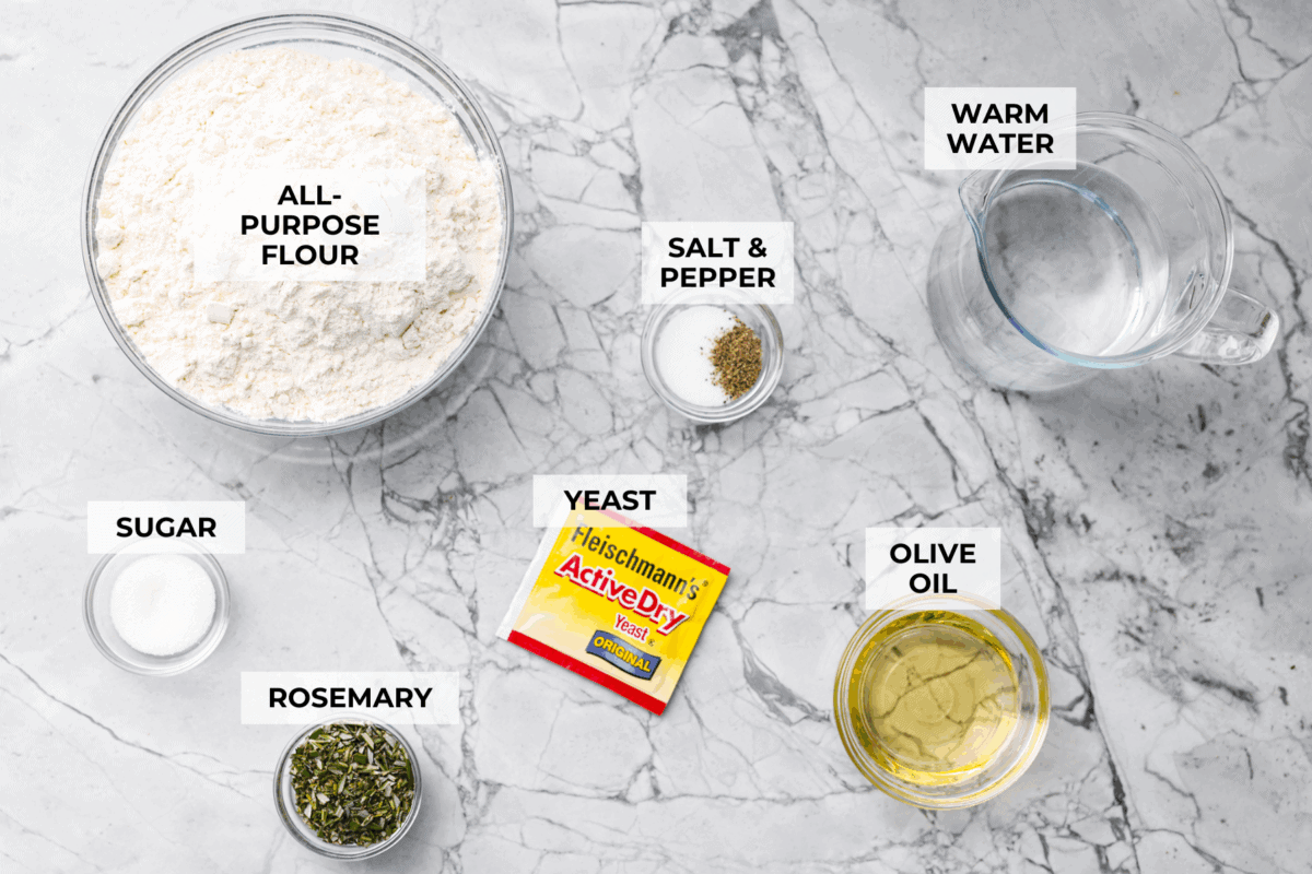 Golden, fluffy, and infused with fresh rosemary and olive oil, this rosemary focaccia is pure perfection! With its crisp edges, soft center, and irresistible herb aroma, it’s the kind of bread that disappears straight off the pan. Overhead shot of labeled ingredients.