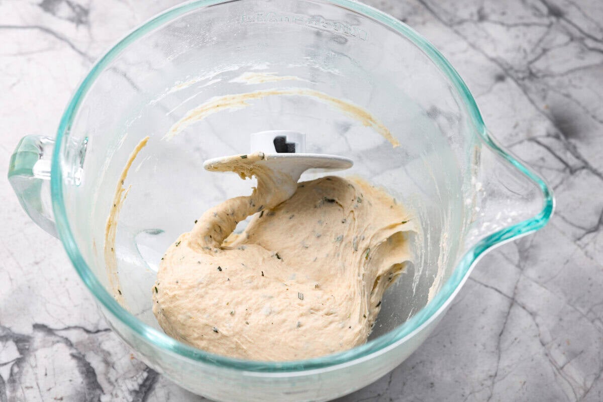 Golden, fluffy, and infused with fresh rosemary and olive oil, this rosemary focaccia is pure perfection! With its crisp edges, soft center, and irresistible herb aroma, it’s the kind of bread that disappears straight off the pan. Dough ingredients mixed together with a dough hook in a mixing bowl.
