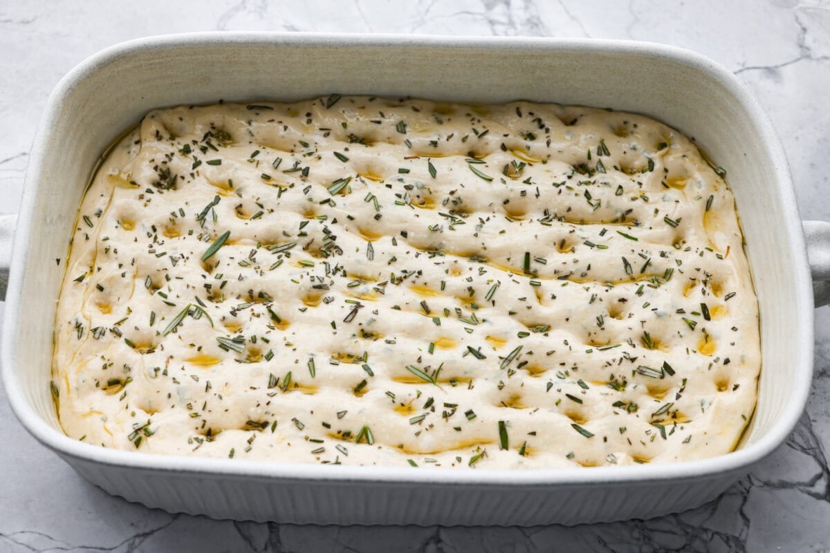 Golden, fluffy, and infused with fresh rosemary and olive oil, this rosemary focaccia is pure perfection! With its crisp edges, soft center, and irresistible herb aroma, it’s the kind of bread that disappears straight off the pan. Fresh rosemary, olive oil, and salt added to the poked dough.