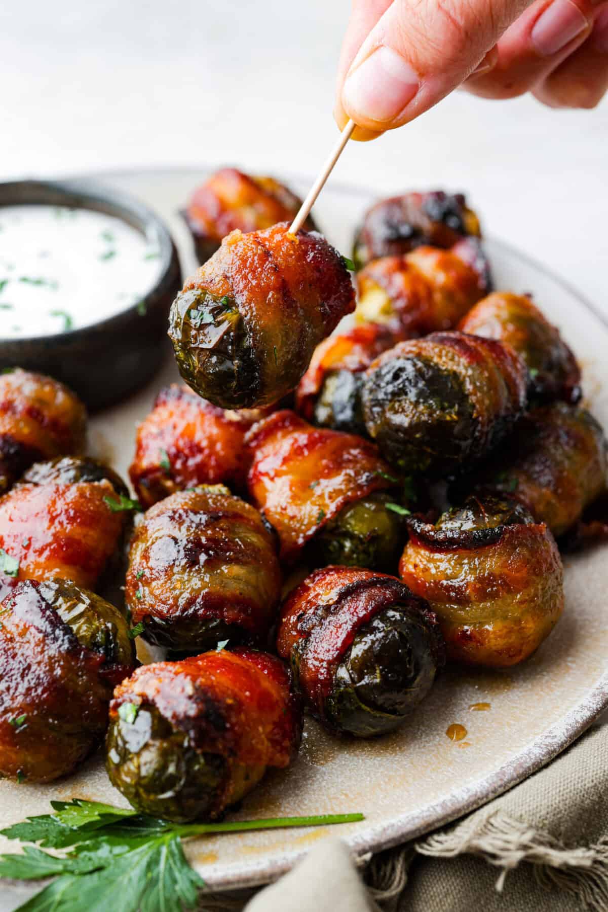 I love bacon. I love Brussels sprouts. Put them together and Iโm sold. Atoothpick in a bacon wrapped brussel sprout.