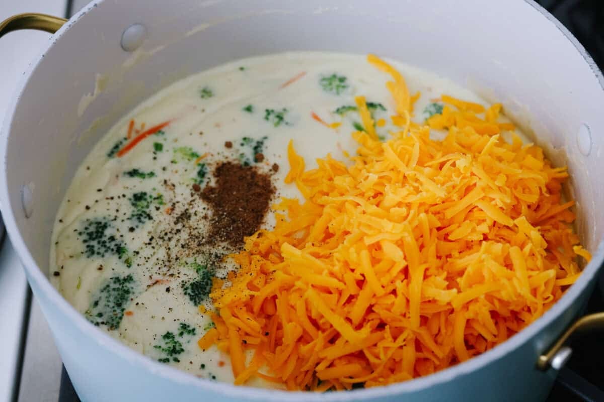 I promise that with just one bite of this copycatย Panera Breadย Broccoli Cheddar Soup, you'll be hooked! It's ultra creamy with broccoli, shredded carrots, and a hint of nutmeg, all cooked together with melted cheese. This soup is delicious and easy to make! Cheese and seasonings added to the soup.