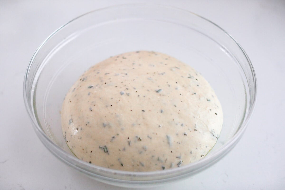 Golden, fluffy, and infused with fresh rosemary and olive oil, this rosemary focaccia is pure perfection! With its crisp edges, soft center, and irresistible herb aroma, it’s the kind of bread that disappears straight off the pan. Dough ball added to an oiled mixing bowl to let rise.