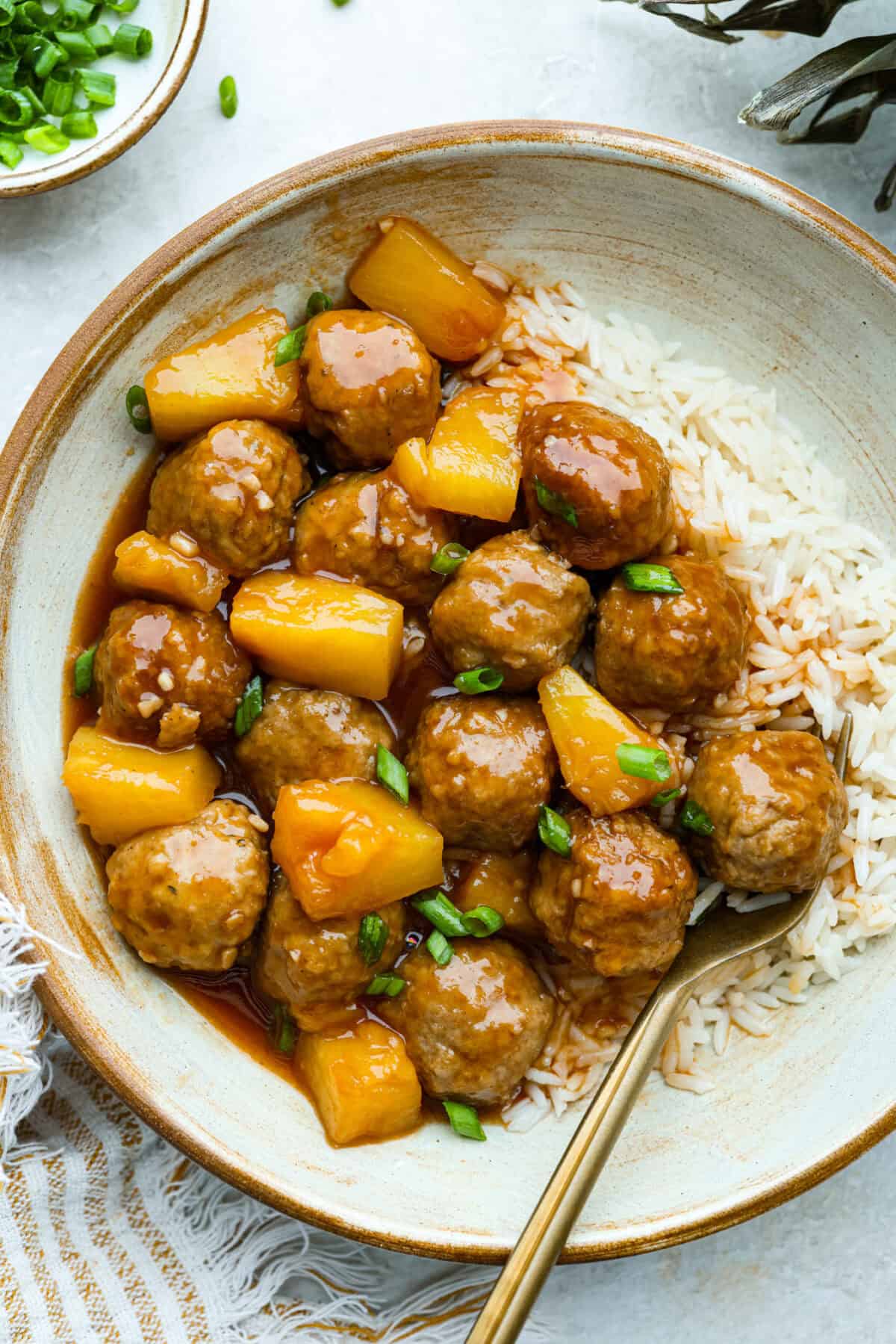 Bring the taste of the tropics to your table with Crockpot Huli Huli Meatballs! Juicy meatballs simmer in a sweet and tangy pineapple-ginger sauce, bursting with island flavor. Image of plated crockpot huli huli meatballs with white rice.