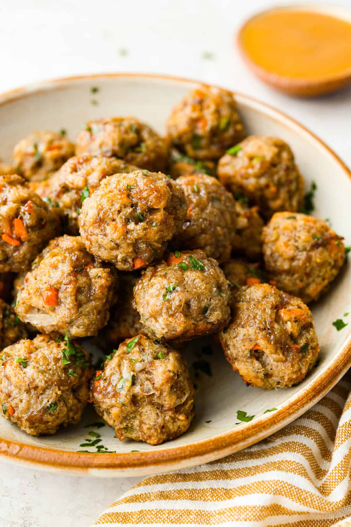 I'm telling you guys right now, sausage stuffing balls are the best part of my holiday table. They're crispy on the outside, soft and savory on the inside, and loaded with classic stuffing flavor. Easy to make, fun to share, and they disappear fast. Plate of stuffing balls.