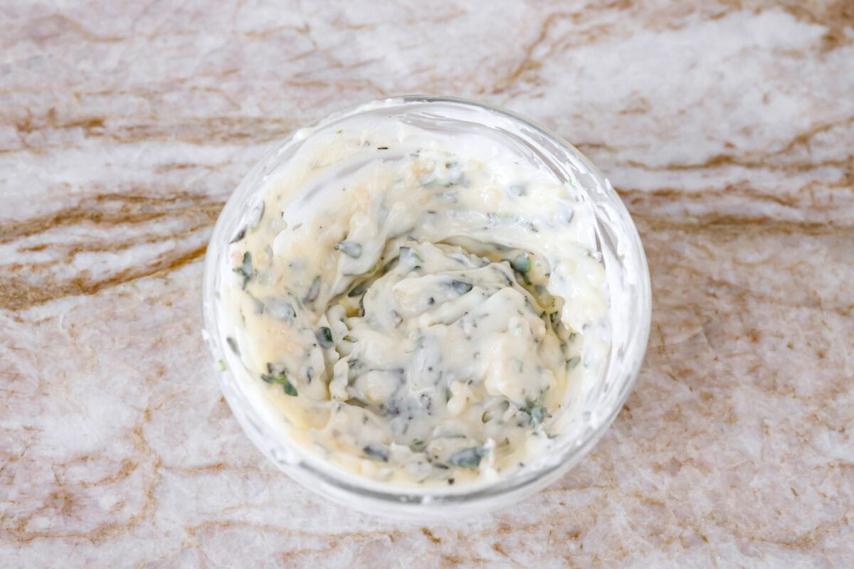 I have the perfect fool proof prime rib recipe for you. I have done all of the testing for you so that you can achieve the perfect prime rib every single time. Melt in your mouth, cooked perfectly to medium rare with a perfect garlic butter crust, this recipe is incredible. I will help you feel confident every step of the way! Garlic herb butter ingredients mixed together in a bowl.