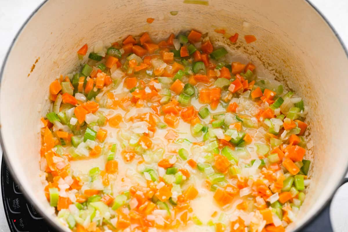 Why did it take me this long to use it in stuffing? Sourdough Stuffing's tangy crustย and the chewy middleย are perfection! Every bite soaks up all that buttery, herby goodness like it was made for this. Veggies and butter cooking in a pot.