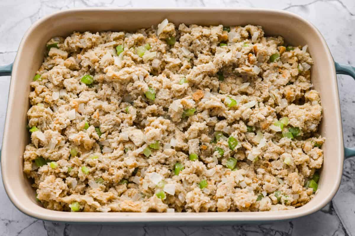 This 5-ingredient stuffing has the same buttery, herby taste as the traditional recipe. All the flavor of classic Thanksgiving stuffing on a budget! You don’t need a long ingredient list to get big holiday flavor. Stuffing ingredients added to the baking dish ready to go in the oven.
