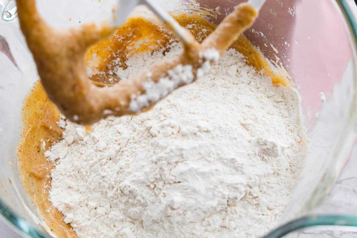 Skip the candy making! These Christmas Crack Cookies give you all the buttery, chocolatey, toffee filled flavor of Christmas crack in one easy cookie recipe. Gooey, salty, and completely irresistible. Dry ingredients added to the wet ingredients in the stand mixer bowl.