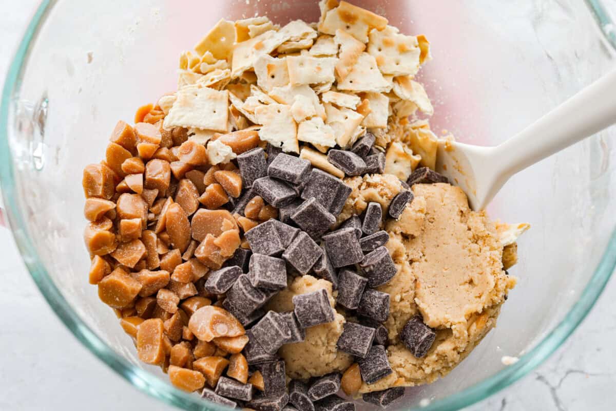 Skip the candy making! These Christmas Crack Cookies give you all the buttery, chocolatey, toffee filled flavor of Christmas crack in one easy cookie recipe. Gooey, salty, and completely irresistible. Chocolate, toffee, and saltine crackers added to the cookie dough.