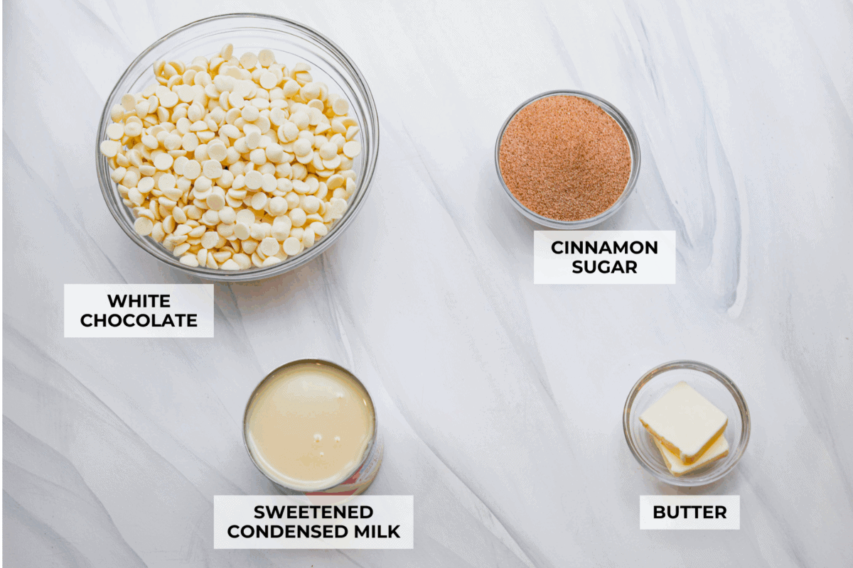 This 4-ingredient churro fudge is pure magic! It's buttery, cinnamon sugary bliss that tastes like a churro and fudge had a baby. Itโs easy to make and even easier to gift (if you can resist eating it all first!). Overhead shot of labeled churro fudge ingredients.