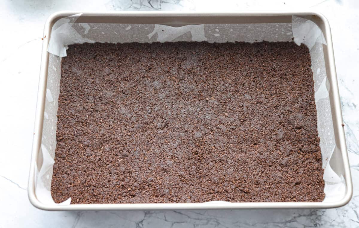 If you love coconut, chocolate, and almonds, these Almond Joy magic bars are the perfect mix. Theyโre gooey in the center, crisp on the edges, and built on a rich chocolate graham crust. Crust ingredients smashed into the bottom of a pan.
