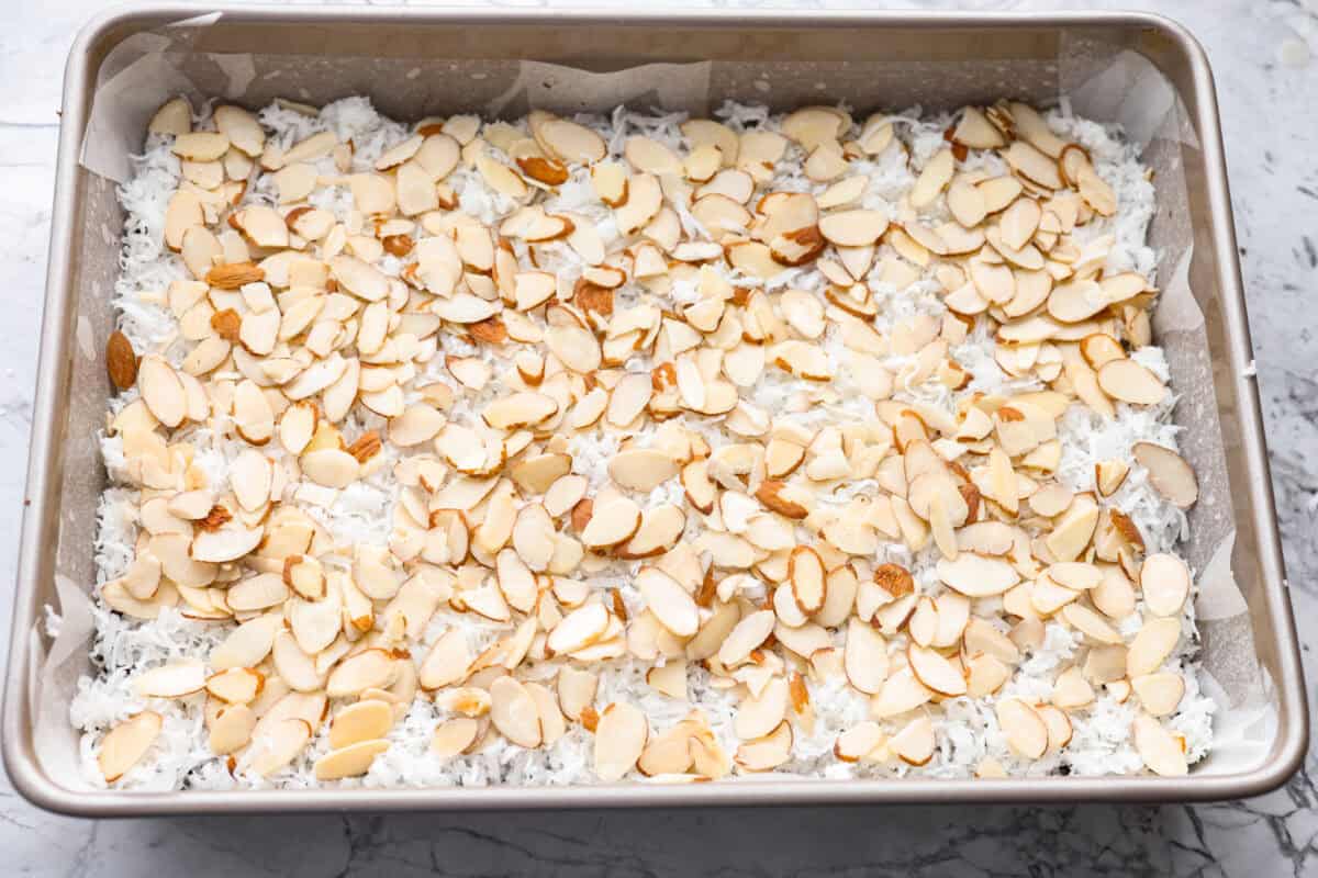 If you love coconut, chocolate, and almonds, these Almond Joy magic bars are the perfect mix. Theyโre gooey in the center, crisp on the edges, and built on a rich chocolate graham crust. Sliced almonds layered over the top of the coconut.