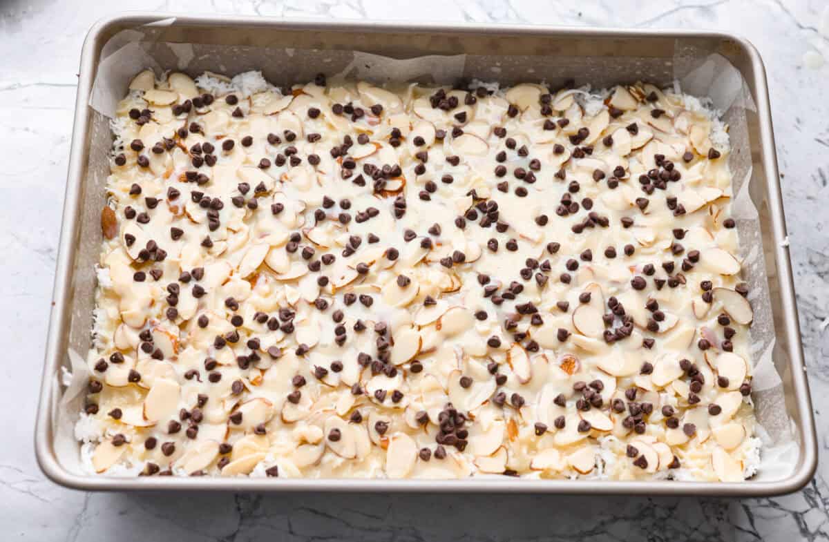 If you love coconut, chocolate, and almonds, these Almond Joy magic bars are the perfect mix. Theyโre gooey in the center, crisp on the edges, and built on a rich chocolate graham crust. A few more chocolate chips sprinkled over the top of the sweetened condensed milk.