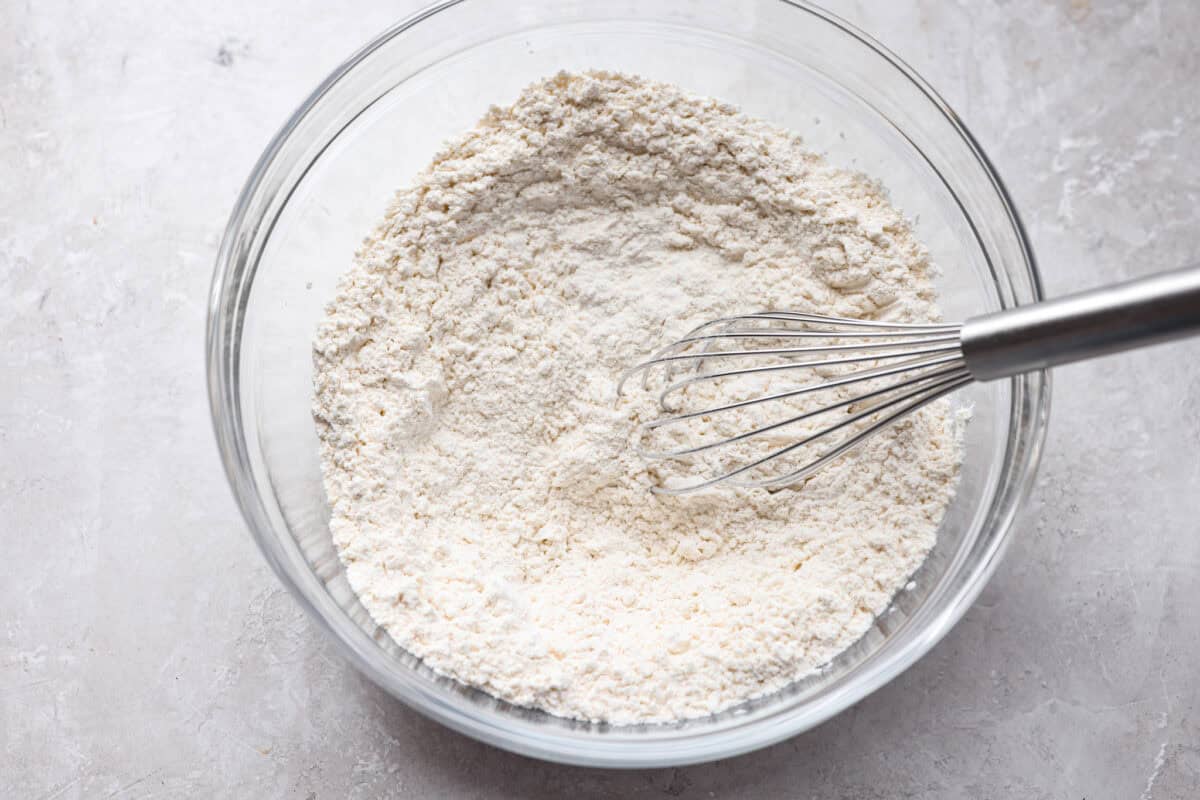 These sprinkle cookies are pure joy. Soft centers, chewy edges, and lots of colorful sprinkles! They are perfect for Christmas parties, cookie exchanges, and neighbor gifts. Bowl of dry ingredients whisked together.