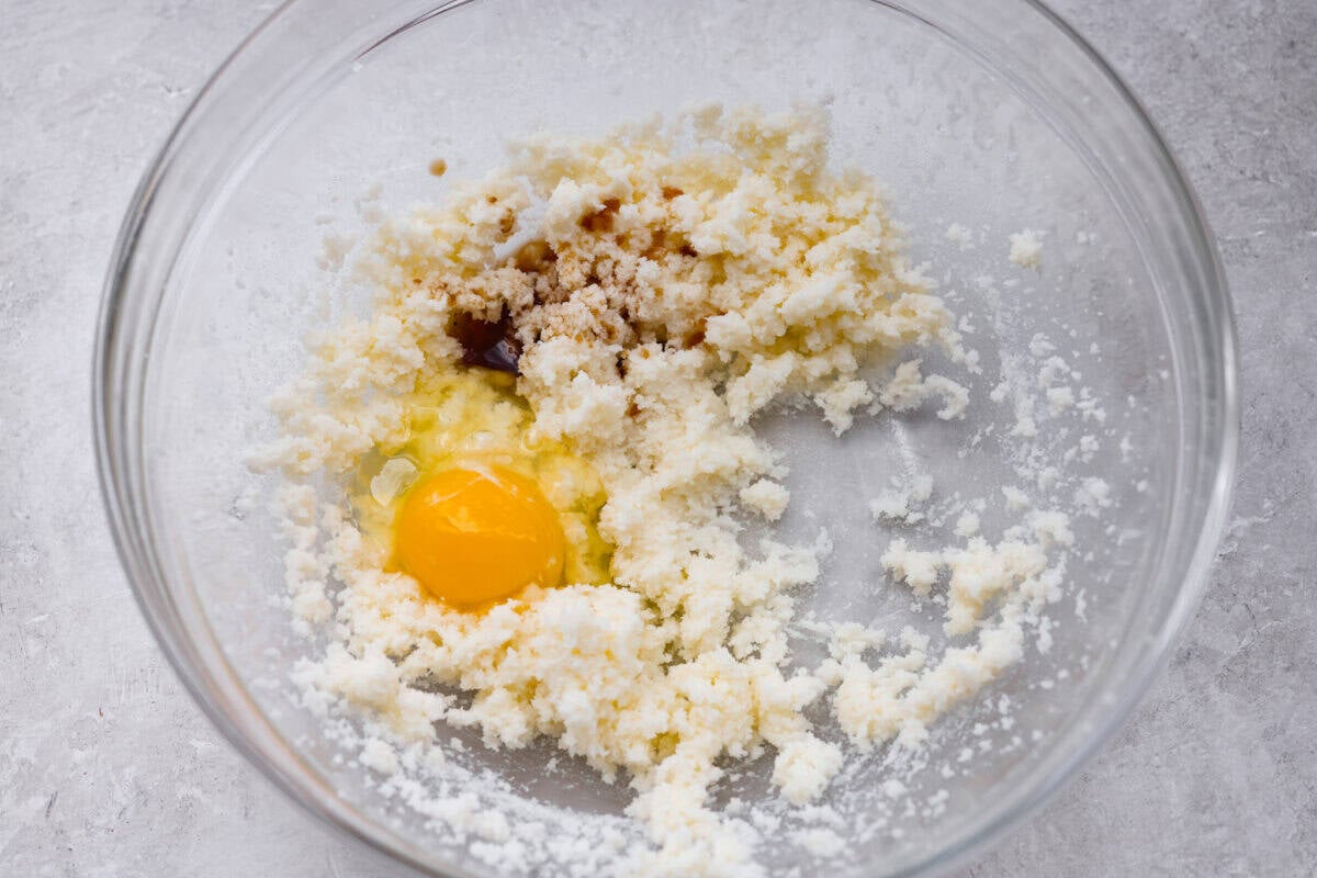 These sprinkle cookies are pure joy. Soft centers, chewy edges, and lots of colorful sprinkles! They are perfect for Christmas parties, cookie exchanges, and neighbor gifts. Bowl of creamed sugar and butter with and egg and both extracts added.