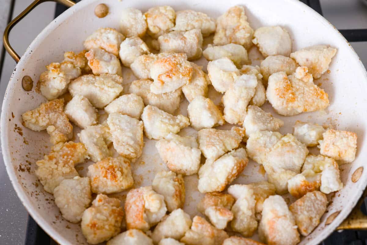 Skip the takeout and make this easy baked General Tso’s chicken at home! It’s crispy, saucy, and perfectly sweet with just the right amount of heat, no deep fryer required. Browning chicken in a skillet.
