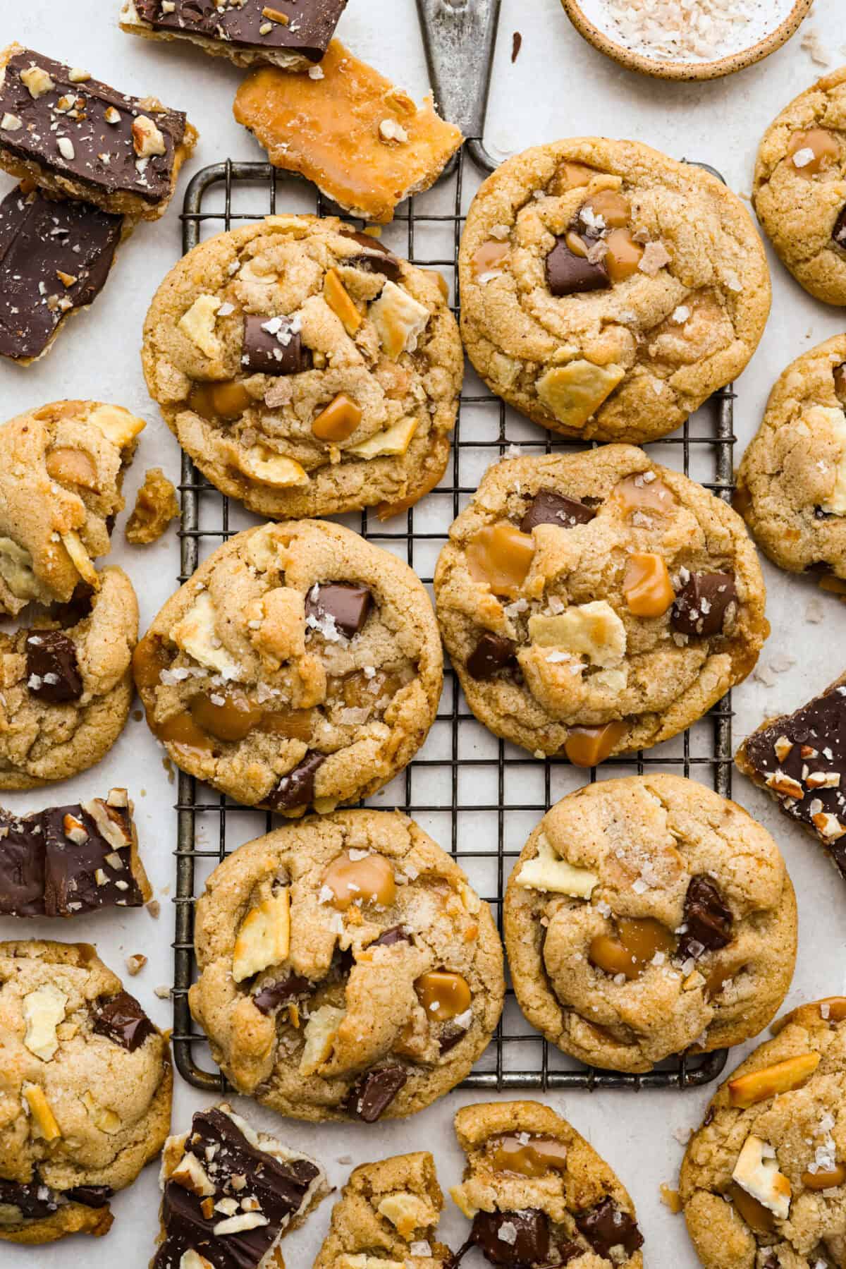 Skip the candy making! These Christmas Crack Cookies give you all the buttery, chocolatey, toffee filled flavor of Christmas crack in one easy cookie recipe. Gooey, salty, and completely irresistible. Overhead shot of Christmas crack cookies on a cooling rack.