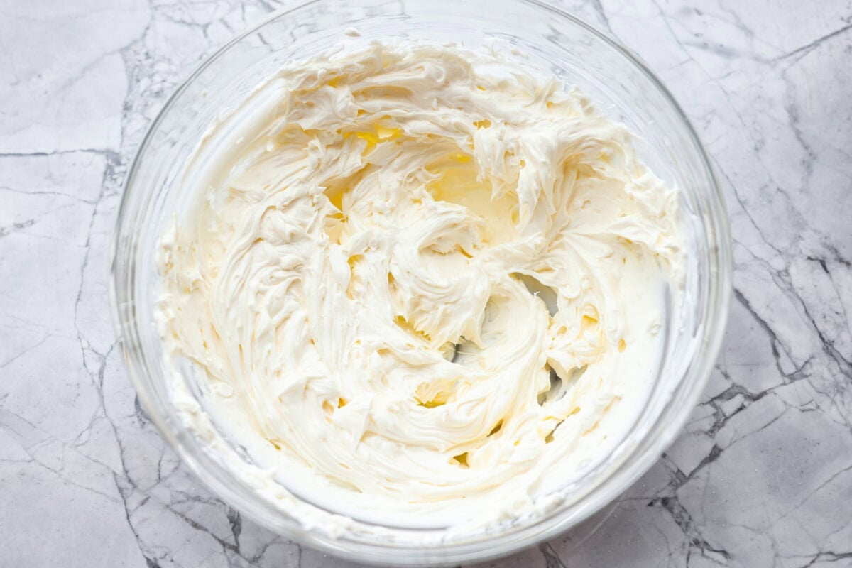This cranberry jalapeño dip is my fresh take on the cult favorite Costco version. It's bright, tangy, a little spicy, and wildly easy to make at home. It’s the same addictive flavor, but you get to make it how you like! Cream cheese and sour cream beaten until smooth in a mixing bowl.