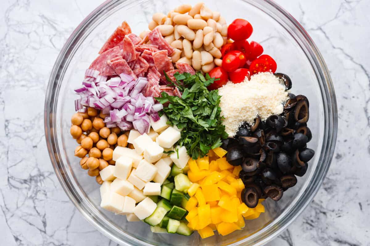 TikTok creator Violet Witchel made this dense bean salad go viral for good reason. Itโs simple, high in fiber, protein-packed, and stays delicious for days. My version keeps the same hearty texture and zesty flavor that made her trend explode. Overhead shot of all of the ingredients added to a large mixing bowl.
