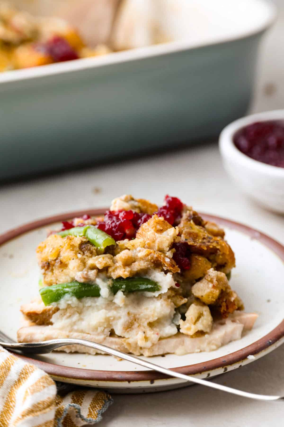 This Thanksgiving leftover casserole is the best way to enjoy every last bit of your holiday meal. I give you tips for keeping it moist, flavorful, and perfectly layered. Plated portion of Thanksgiving leftover casserole.
