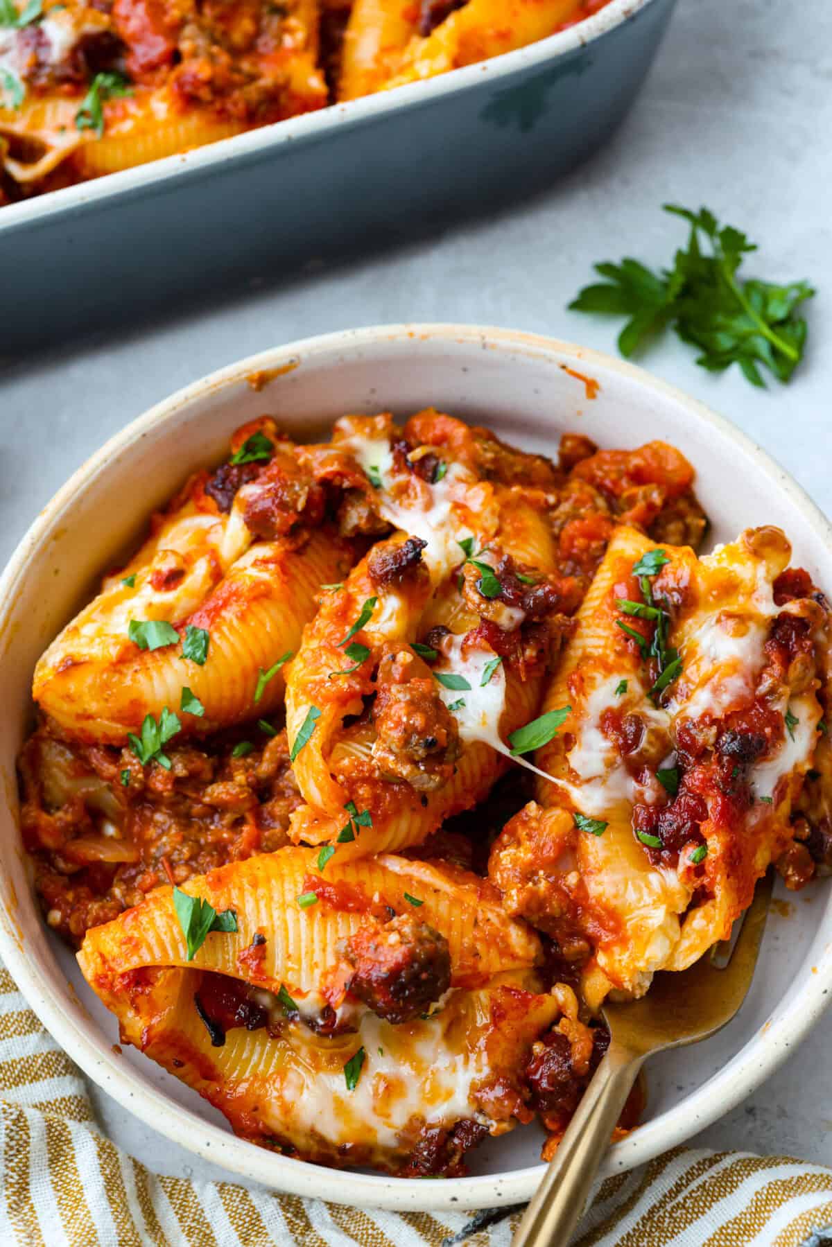 https://www.target.com/p/rao-39-s-homemade-marinara-sauce-premium-quality-all-natural-tomato-sauce-38-pasta-sauce-keto-friendly-38-carb-conscious-24oz/-/A-13349580#lnk=sametab Plated serving of million dollar stuffed pasta with a gold fork and garnished with parsley.