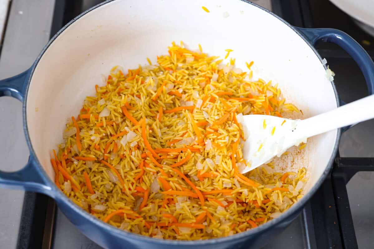 You guys are obsessed with my Broccoli Cheddar soup, and I know you love a good orzo recipe. So this simple, one-pot, ready-in-30-minute Broccoli Cheddar Orzo was born! Orzo added to the pan of cooked veggies.