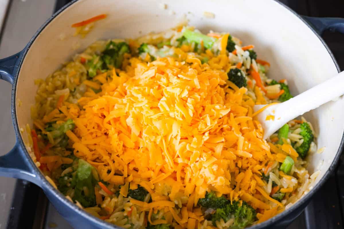 You guys are obsessed with my Broccoli Cheddar soup, and I know you love a good orzo recipe. So this simple, one-pot, ready-in-30-minute Broccoli Cheddar Orzo was born! Cheese added to the pot.