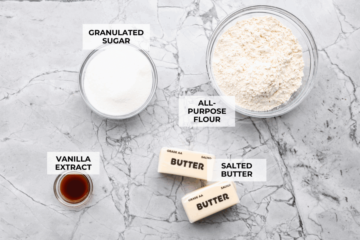 Simple to make and impossible to resist, these 4 ingredient sugar cookies are soft, tender, and sweet. A quick mix, a little roll, and your kitchen will smell like pure cookie heaven! Overhead shot of labeled 4 ingredient sugar cookie ingredients.