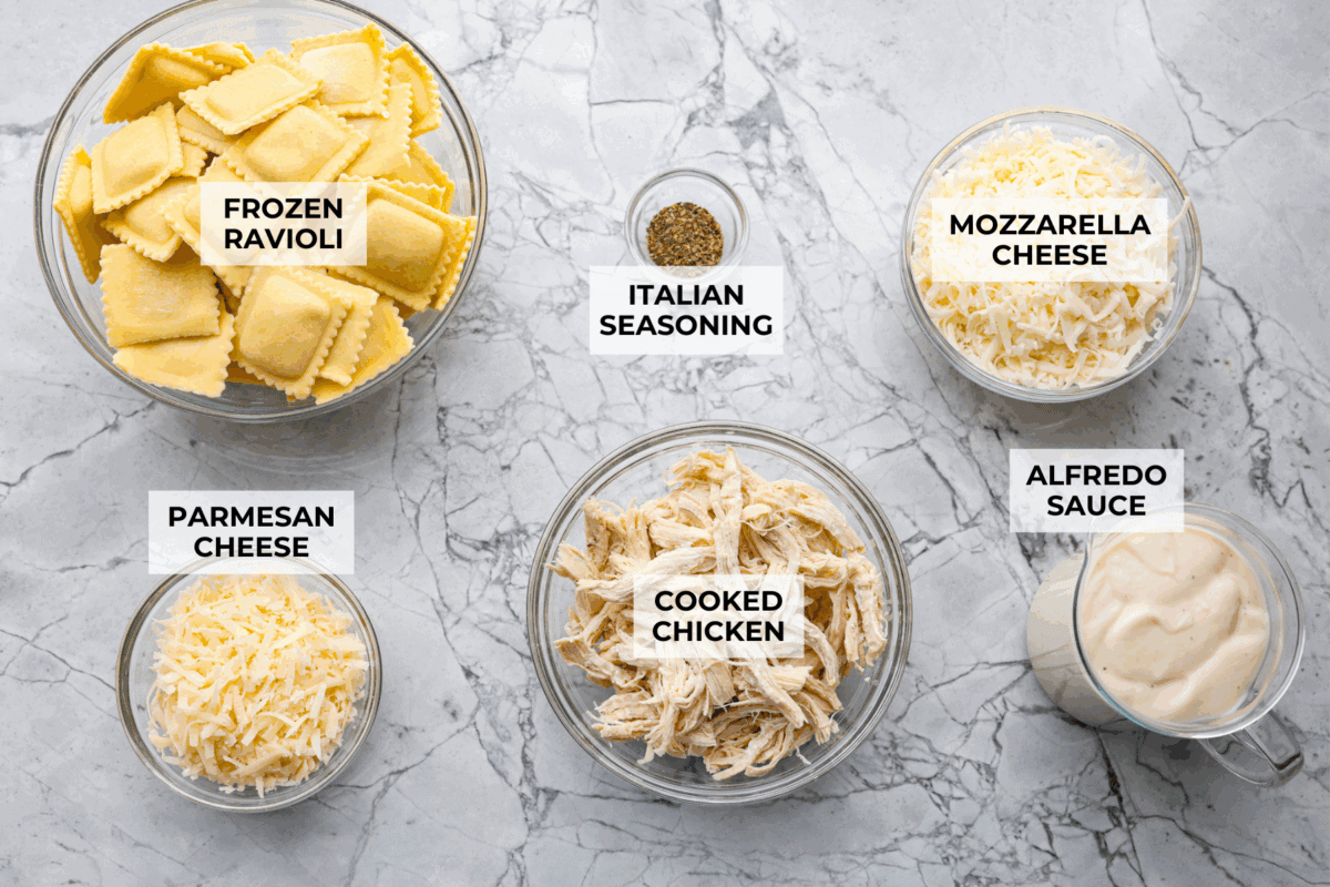 By the end of the day, Iโm wiped and still somehow expected to make dinner. I'm telling you, this Alfredo ravioli casserole will swoop in and save the day! Simply layer, bake, and enjoy! Overhead shot of labeled ingredients.