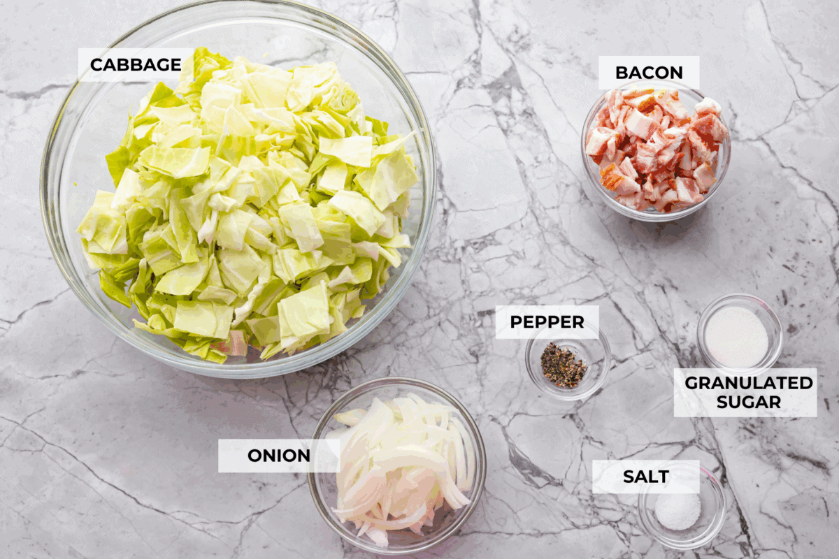 You donโt need fancy ingredients to make something great, and this fried cabbage proves that! Bacon, cabbage, a little seasoning, and a hot skillet. Thatโs it. And it works every single time. Overhead shot of labeled ingredients.