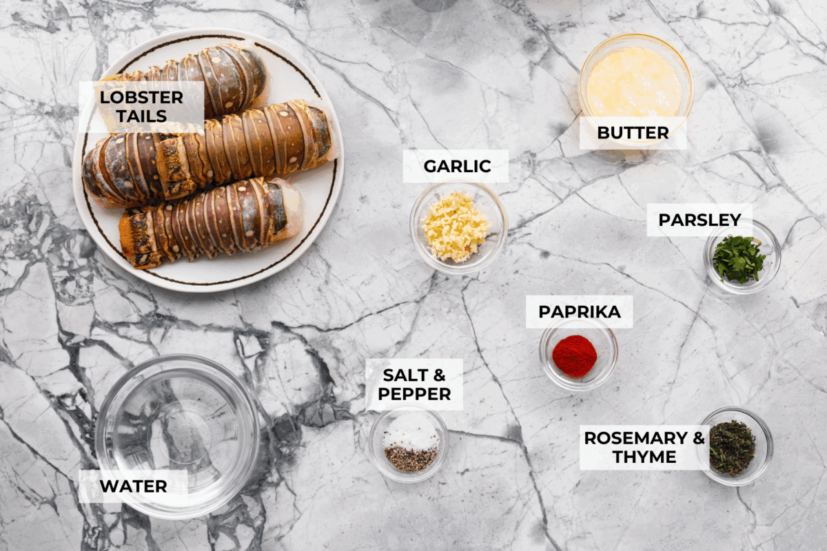 Instant pot lobster is the easiest way to bring a little luxury to your dinner table, no boiling pots or fancy techniques needed! In just minutes, the lobster cooks up tender, juicy, and perfectly steamed, ready to soak up a rich garlic herb butter. Overhead shot of labeled instant pot lobster ingredients.