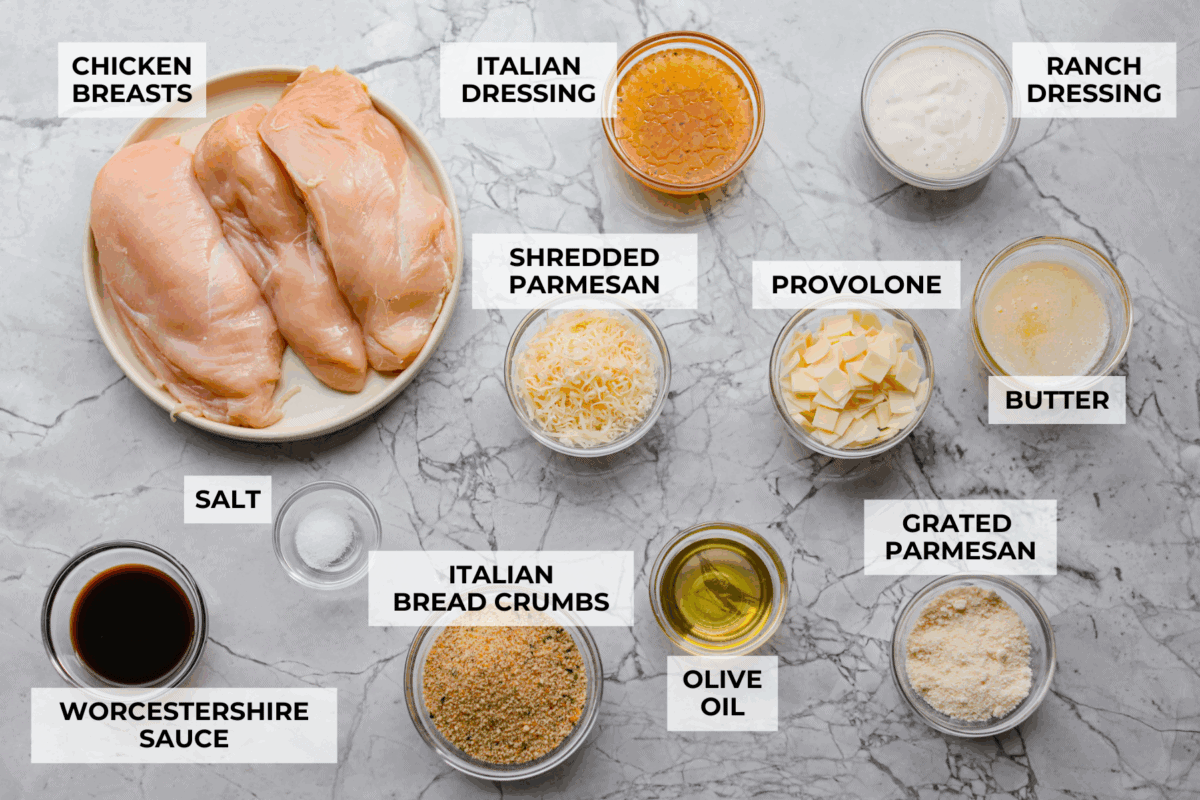 My copycat Longhorn parmesan crusted chicken brings all the cheesy, buttery goodness from the restaurant straight to your kitchen. Juicy ranch chicken is topped with a creamy cheese sauce and a golden crumb crust. Overhead shot of labeled longhorn parmesan crusted chicken ingredients.