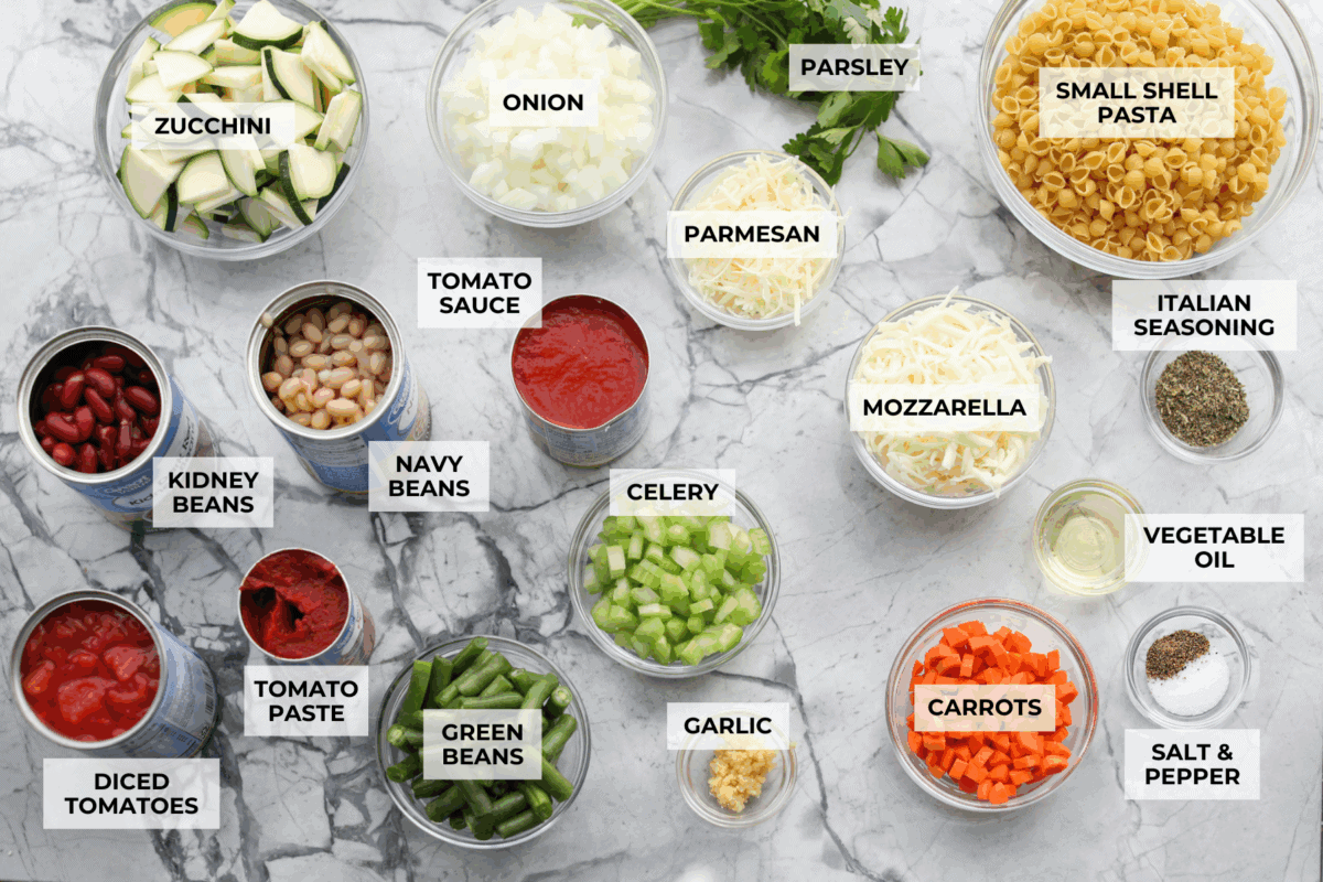 If you love my minestrone soup even a little, you have to try this minestrone casserole. It takes the cozy, veggie packed soup you already love and turns it into a hearty, cheesy pasta bake. It feels like weeknight dinner perfection. Overhead shot of labeled minestrone casserole ingredients.