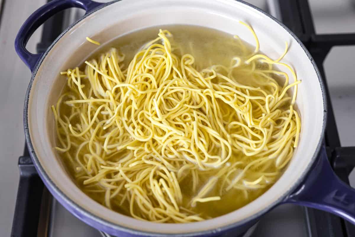 Skip the takeout, this Beef Chow Mein is ready in just 25 minutes! Packed with tender beef, crisp veggies, and saucy noodles, it’s a fast, flavorful dinner that hits the spot every time. Chow mein noodles cooking in a pot on the stove.