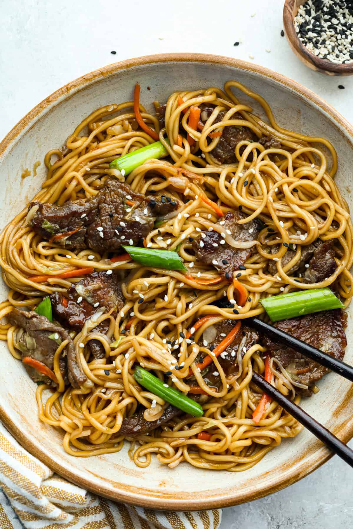 Skip the takeout, this Beef Chow Mein is ready in just 25 minutes! Packed with tender beef, crisp veggies, and saucy noodles, it’s a fast, flavorful dinner that hits the spot every time. Overhead shot of a plated bowl of beef chow mein.