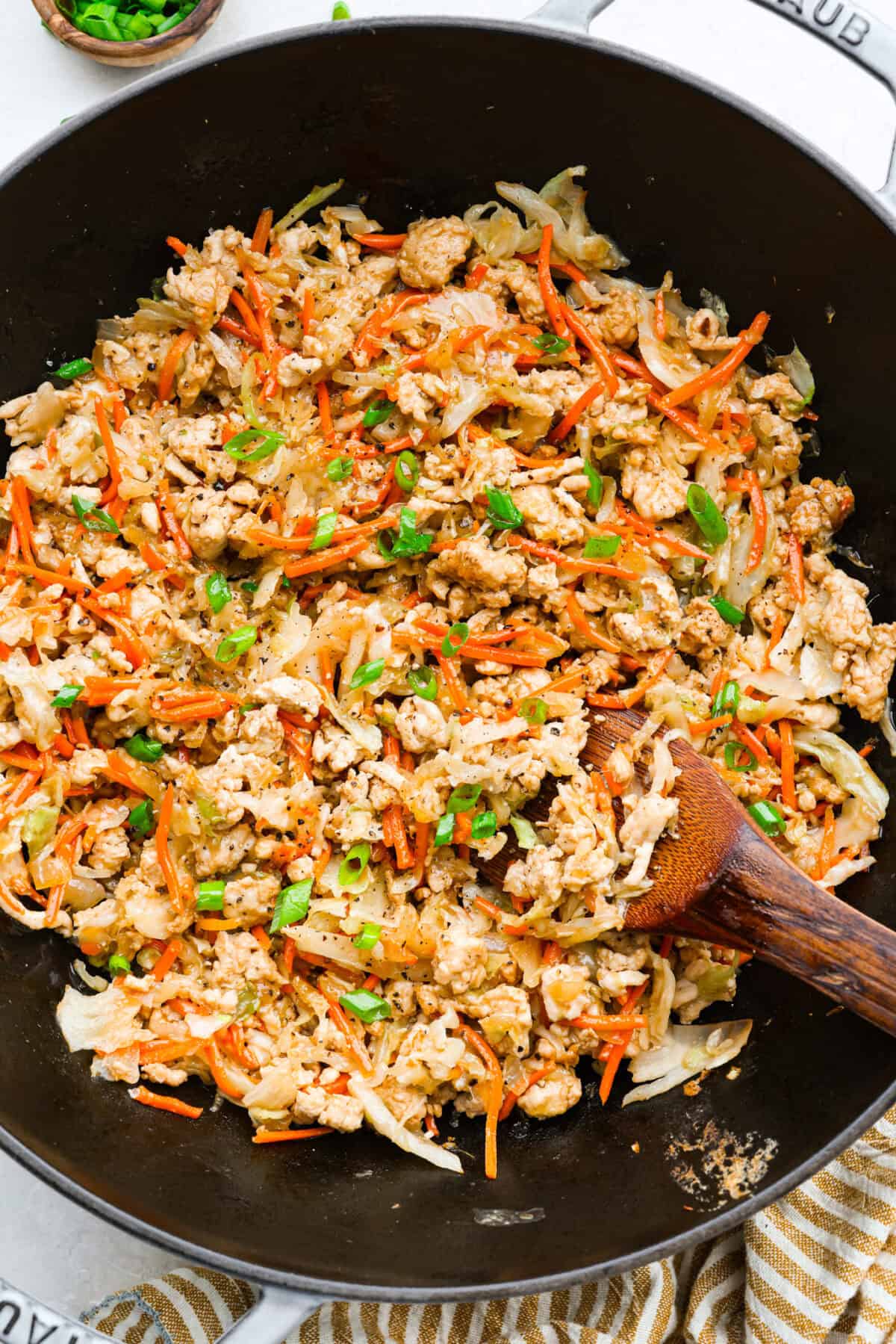 If you havenโt tried egg roll in a bowl yet, youโre in for a treat. Everything you love inside of an egg roll in a lighter, healthier, no-wrapper version! It's ready in 15 minutes, making it a perfect weeknight meal! Egg roll in a bowl all cooked and ready to serve.