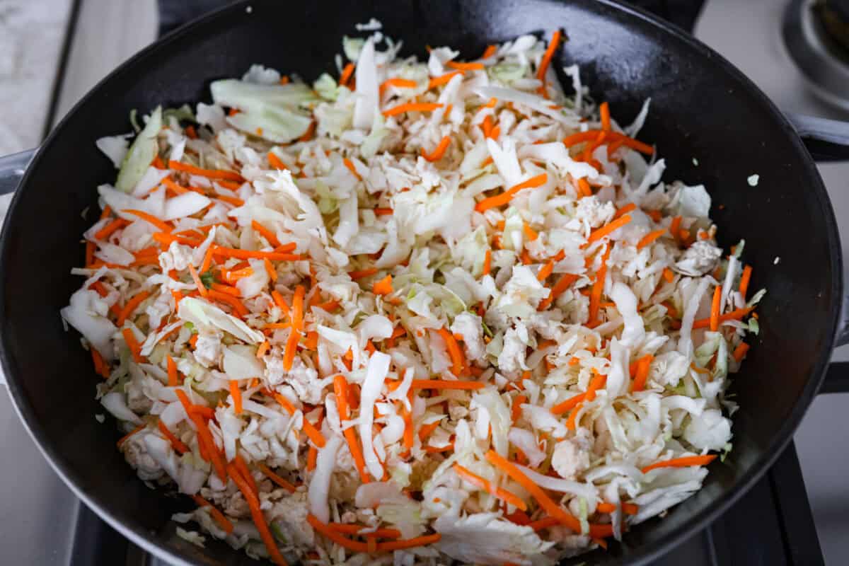 If you havenโt tried egg roll in a bowl yet, youโre in for a treat. Everything you love inside of an egg roll in a lighter, healthier, no-wrapper version! It's ready in 15 minutes, making it a perfect weeknight meal! Coleslaw mix added to the skillet to cook down.