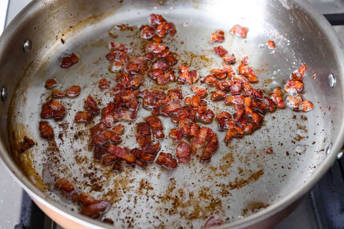 You donโt need fancy ingredients to make something great, and this fried cabbage proves that! Bacon, cabbage, a little seasoning, and a hot skillet. Thatโs it. And it works every single time. Bacon pieces cooking in a skillet.