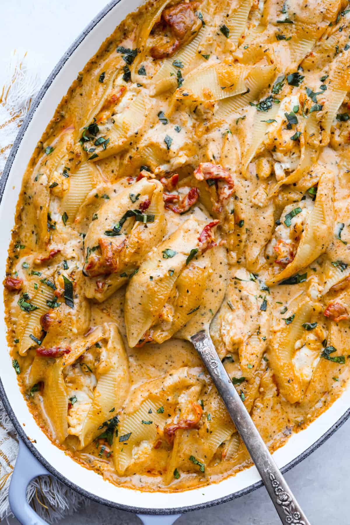 Marry me stuffed shellsย take the viral sauce you love and turn it into a cozy, baked pasta moment. Think creamy chicken-stuffed shells, melty cheese, and just enough sun-dried tomatoes for that extra swoon-worthy touch. Close up of the completed marry me stuffed shells dish.