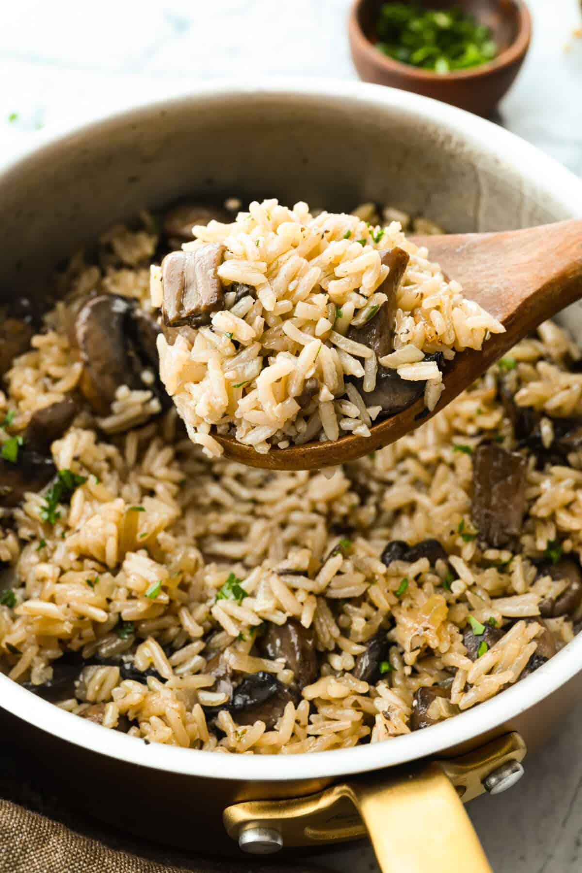 This mushroom rice is way better than a simple side. The secret is a splash of Worcestershire. It enhances the mushrooms and gives the rice this rich, almost buttery flavor. Try it, and you will see exactly what I mean. Someone scooping a spoonful of mushroom rice.