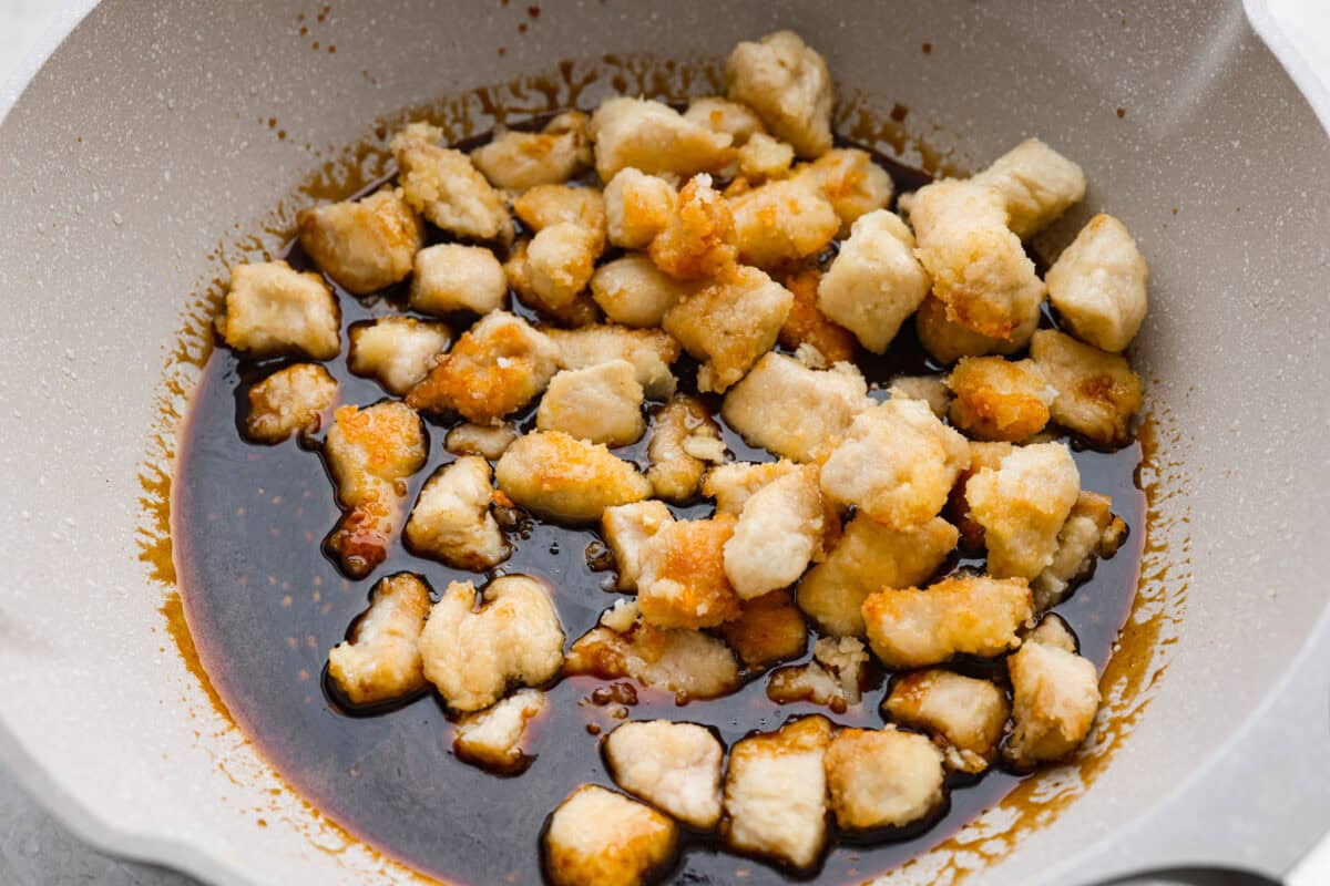 You love my baked General Tso’s chicken, so obviously, I had to make a faster one. This one pan General Tso's chicken is sticky, saucy, and on the table in about 30 minutes. Cooked chicken added to the sauce in the skillet.