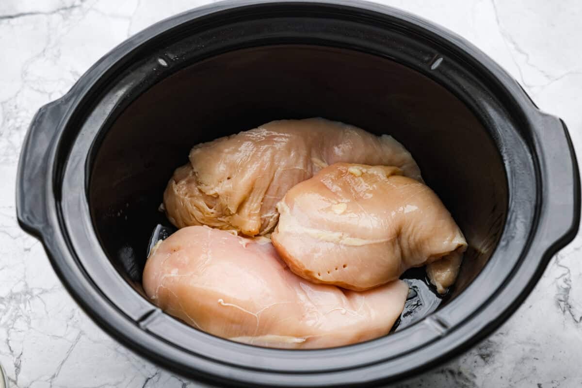 If you love my classic poppyseed chicken casserole, this crockpot poppyseed chicken is the easiest way to make it. Same creamy, buttery flavor. Same cozy comfort. Crockpot with chicken breasts in the bottom.