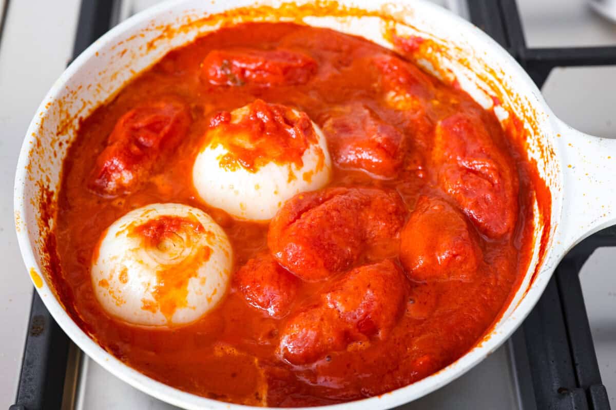 Simple, classic, and downright magical, this iconic Marcella Hazan's tomato sauce uses only 3 ingredients and proves that less is more. With just tomatoes, butter, and onion, it turns pantry staples into a rich, silky sauce you’ll make on repeat. All of the ingredients simmering together on the stove.